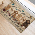 Goldendoodle door mat positioned at an entryway, featuring curly dogs, butterflies, flowers, and inspirational lettering