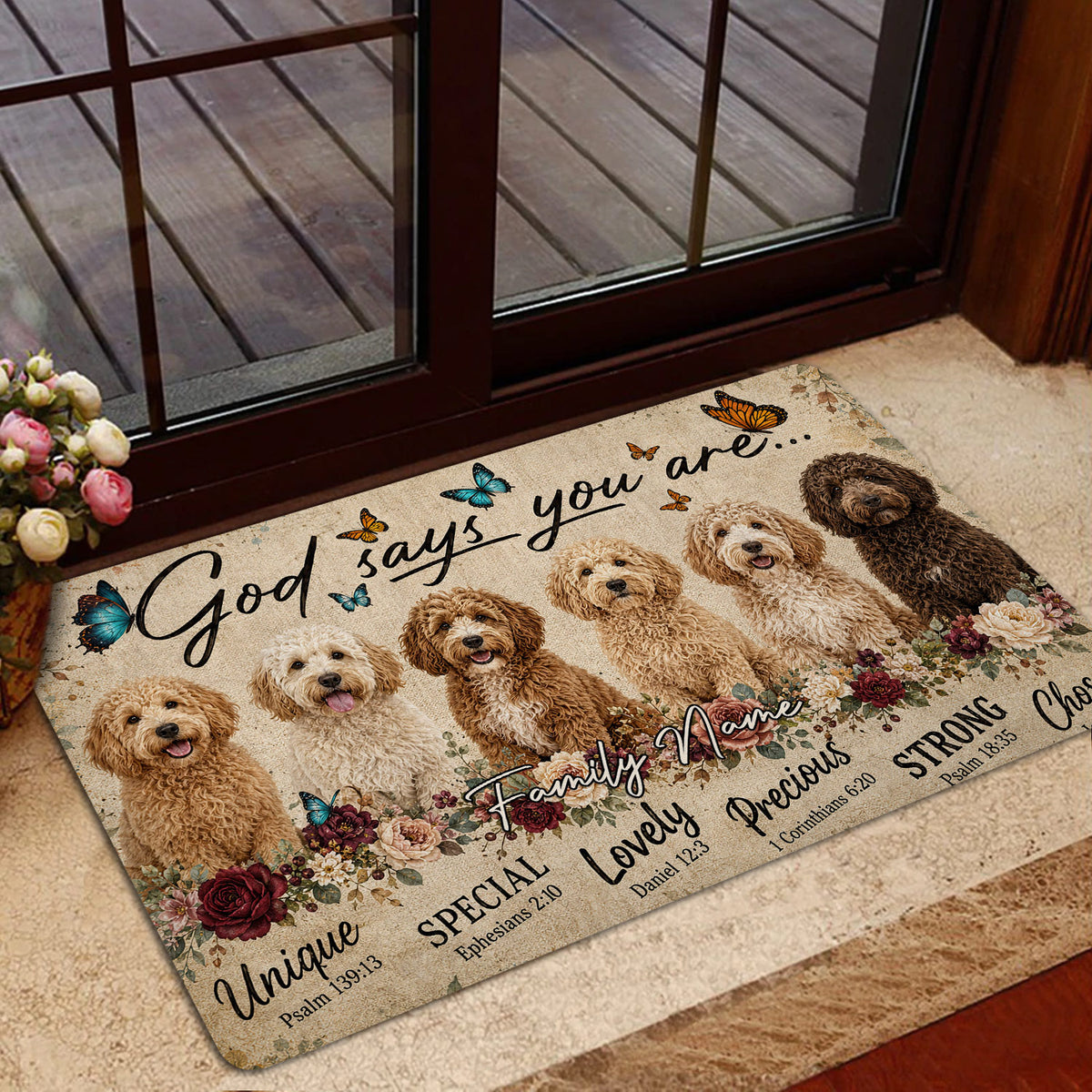 Goldendoodle doormat displayed near a glass door with floral artwork, butterflies, and multiple cheerful dogs
