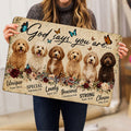 Woman holding a Goldendoodle doormat featuring six dogs, butterflies, flowers, and uplifting faith-inspired artwork