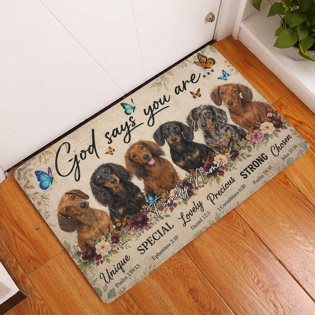 Dachshund doormat displayed by a white entry door on a warm wood floor with floral and butterfly artwork