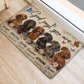 Dachshund entryway rug shown beside a doorway with six dogs, flowers, butterflies and inspirational lettering