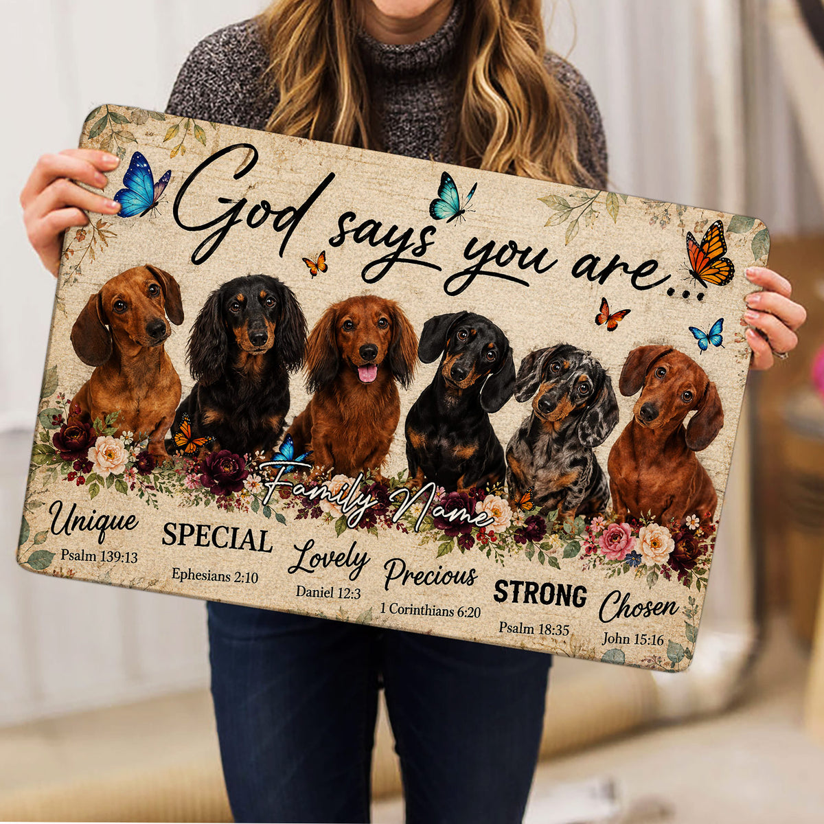 Dachshund doormat held indoors, showing six illustrated dogs, colorful butterflies, flowers and inspirational words