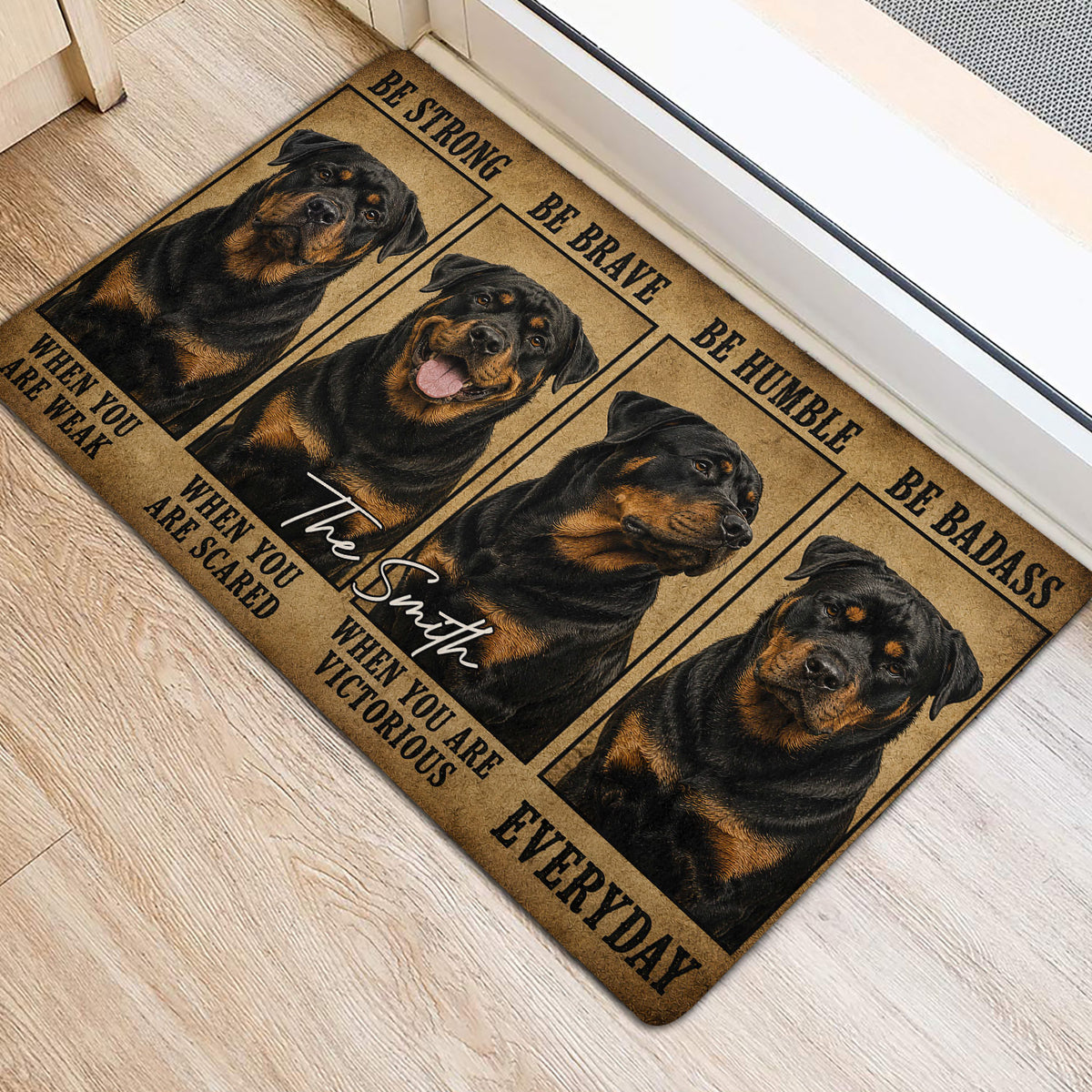 Rottweiler entryway mat positioned beside a doorway, featuring four illustrated dogs and bold black lettering