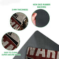 Close-up of Husky doormat artwork with vintage warning graphics and rubber backing detail