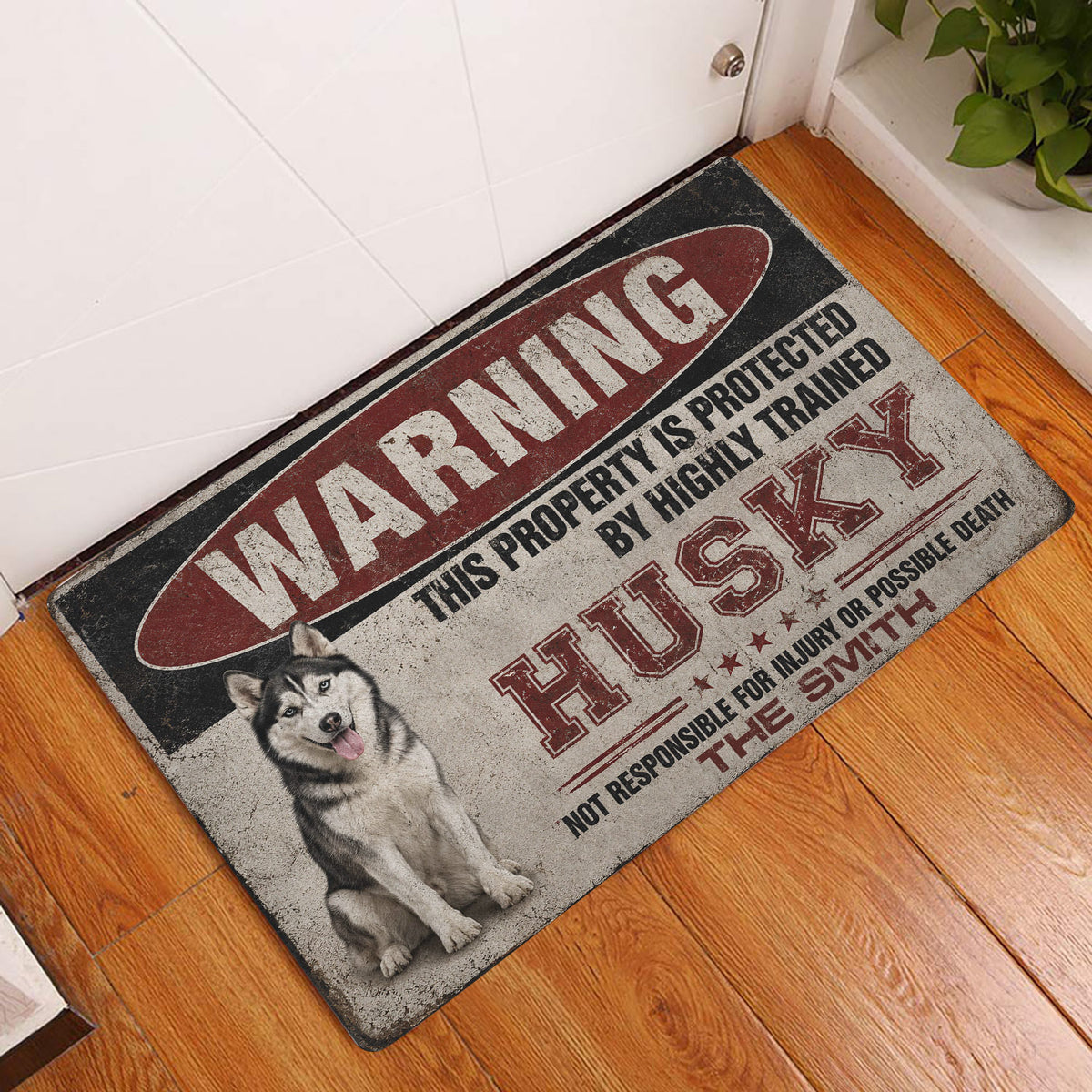 Husky warning-sign doormat displayed by an interior doorway on a wood floor