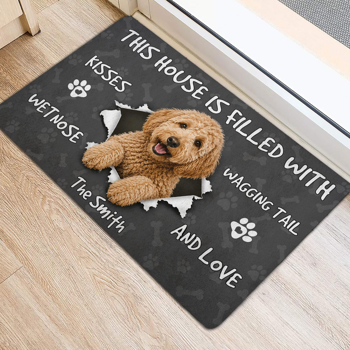 Goldendoodle door mat by an entrance featuring a cheerful dog portrait and playful paw print design
