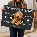 Person holding a Goldendoodle doormat featuring a curly dog portrait, paw prints and playful lettering