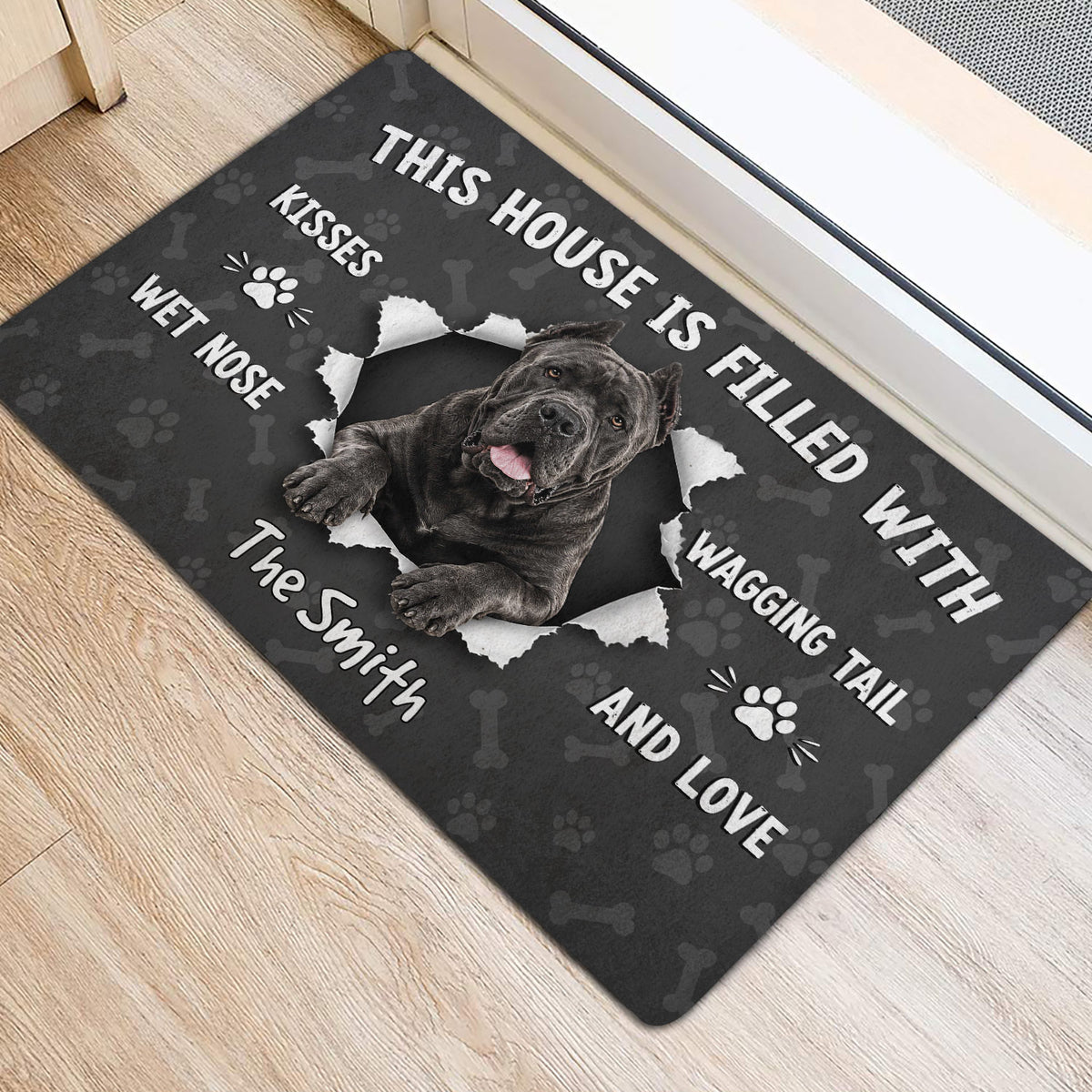 Cane Corso entryway mat with bold white lettering beside an interior doorway