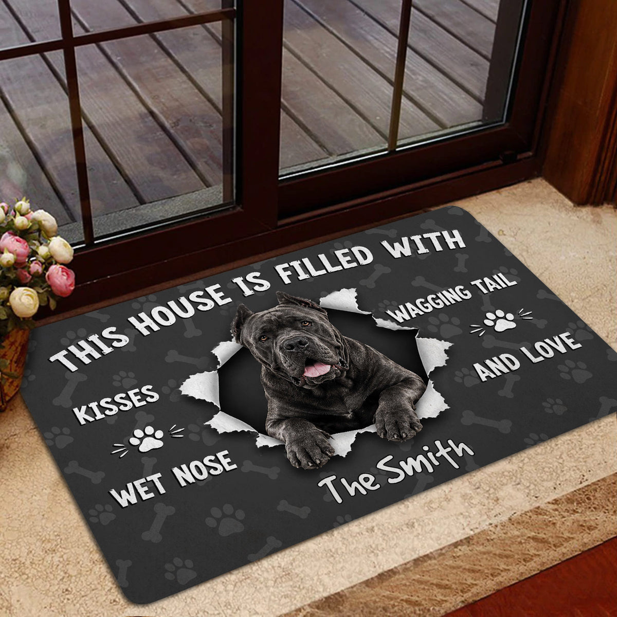 Cane Corso dog doormat styled at a glass door entrance with a dark pet-themed design
