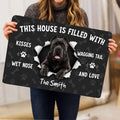 Cane Corso doormat held indoors, showing the dog portrait, paw prints and bone pattern