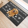 Golden Retriever entryway mat shown beside a door with playful dog-themed artwork