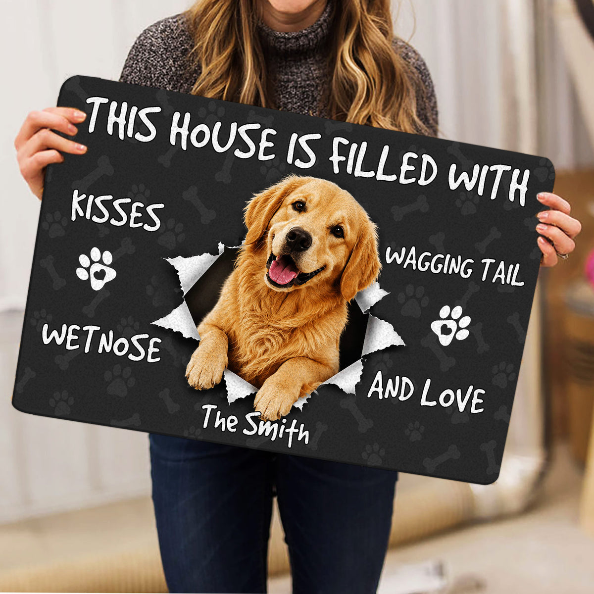 Golden Retriever doormat held indoors, featuring a happy dog and paw print design