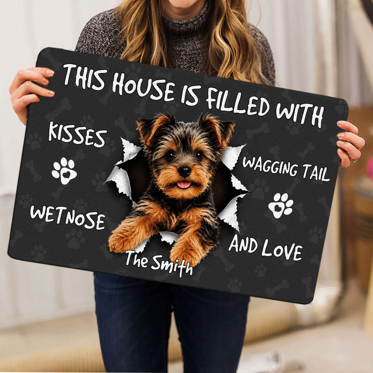 Yorkie doormat held indoors, featuring a cheerful Yorkshire Terrier and playful welcome artwork