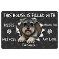 Miniature Schnauzer doormat with a black paw and bone pattern, portrait artwork, and playful dog-themed lettering