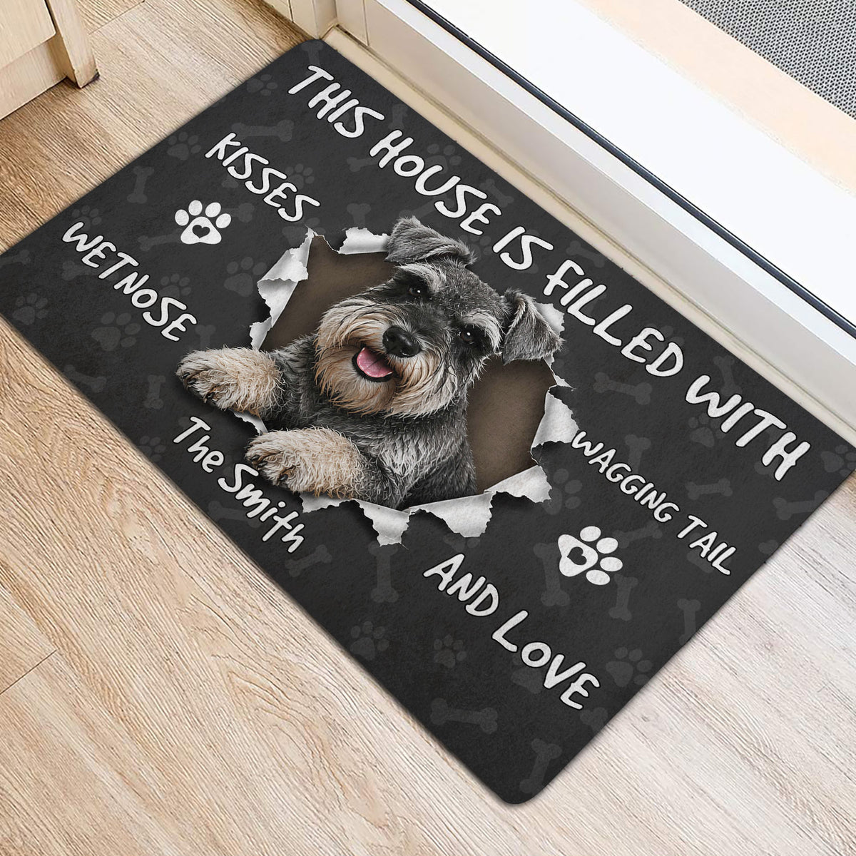 Miniature Schnauzer entryway rug displayed near a doorway with a centered dog portrait and paw print pattern