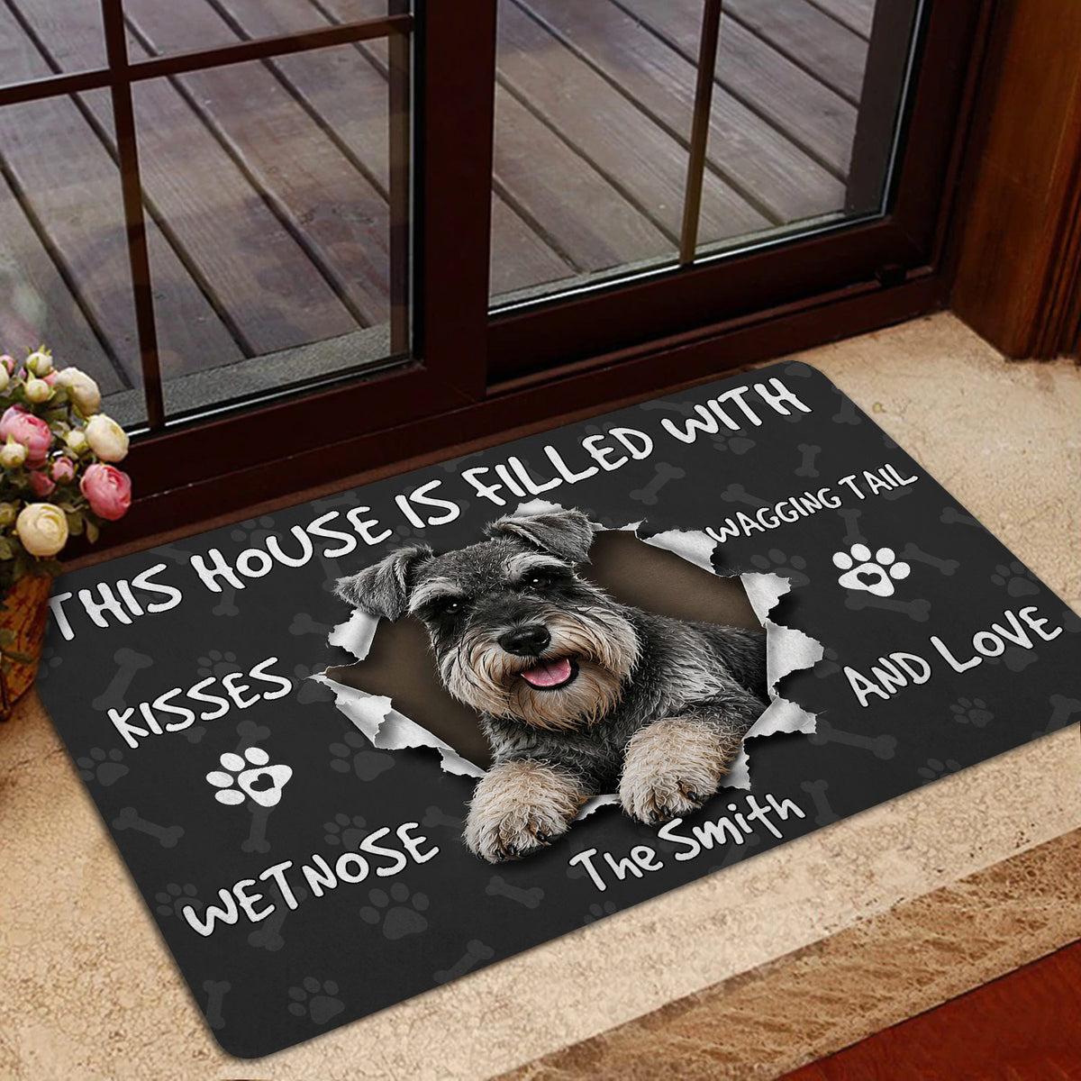 Miniature Schnauzer door mat shown in a home entrance beside a glass door and indoor flooring