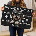 Person holding a Miniature Schnauzer doormat featuring a joyful dog portrait and dark paw print design