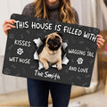 Person holding a pug doormat with a central pug illustration and playful dog-themed lettering