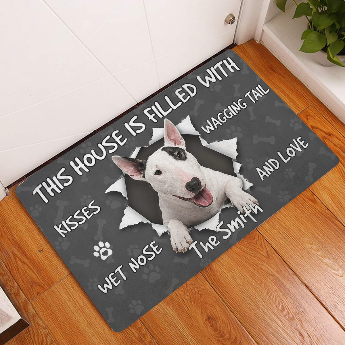 Bull Terrier doormat displayed on a wood floor beside an interior doorway