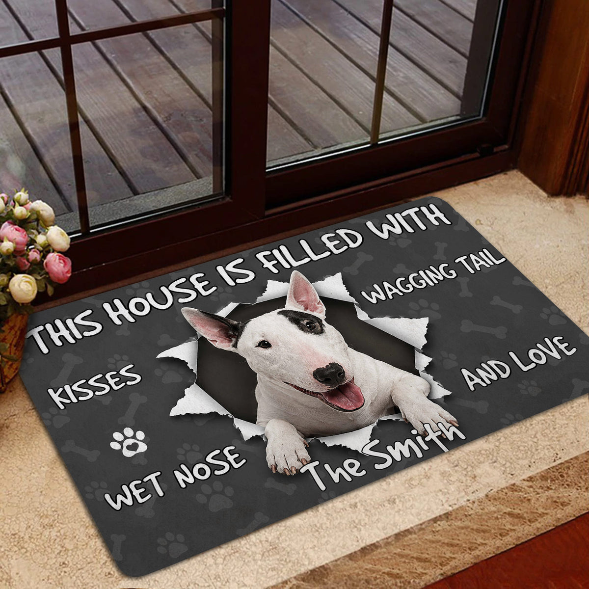 Bull Terrier doormat styled inside near a glass door with a playful dog portrait