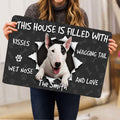 Person holding a Bull Terrier doormat featuring a white dog portrait and paw print artwork