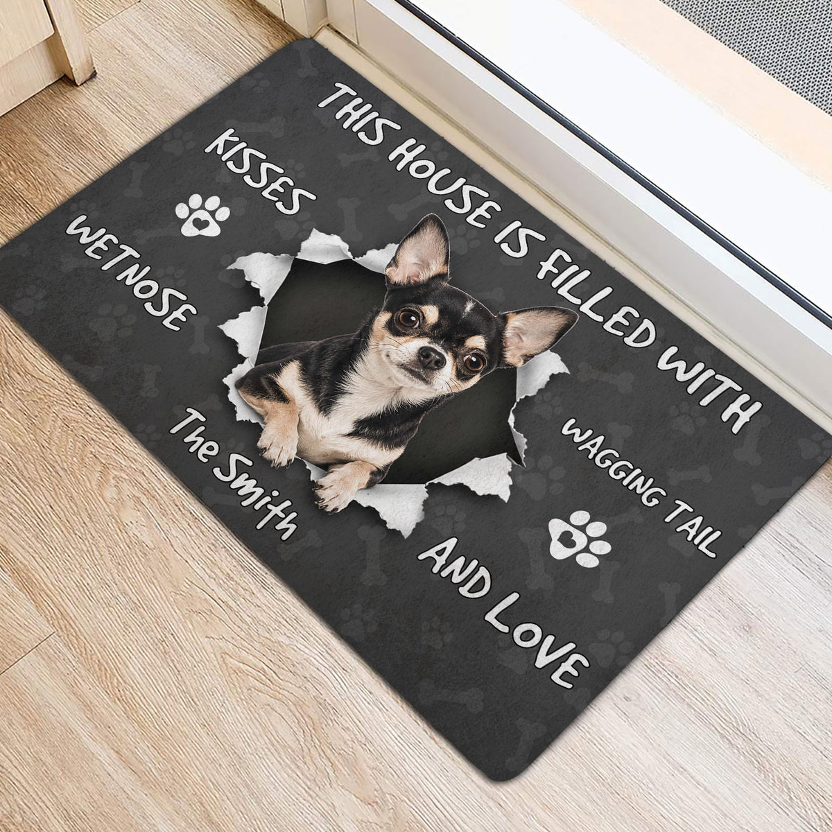 Chihuahua door mat styled at an entrance with a black background, paw prints, and dog-themed lettering