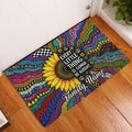 Colorful hippie sunflower doormat displayed in a wood-floored entryway beside a white door