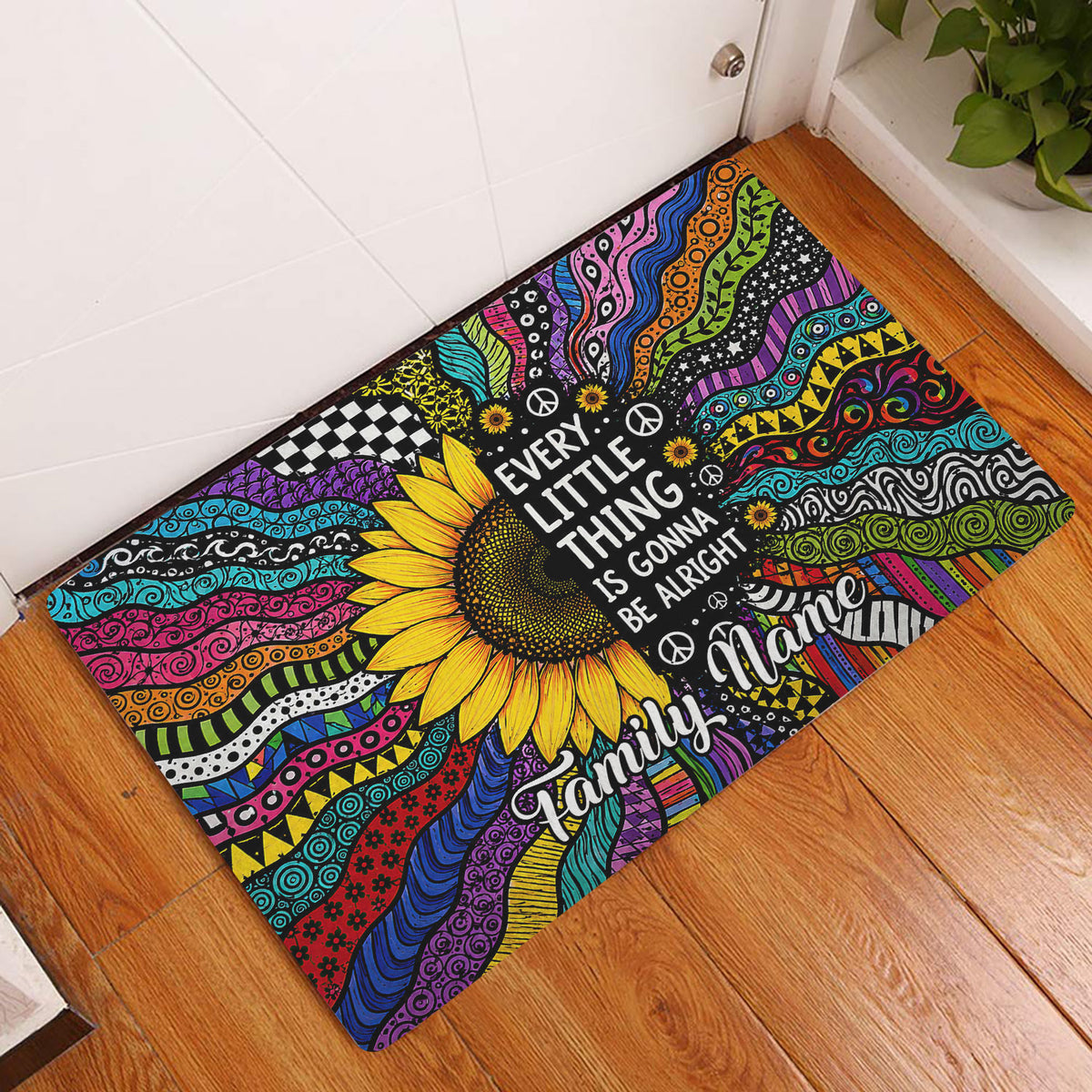 Colorful hippie sunflower doormat displayed in a wood-floored entryway beside a white door