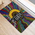 Psychedelic hippie sunflower door mat positioned at an indoor entrance with bold patterned artwork