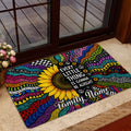 Vibrant hippie doormat with sunflower and peace symbols placed by a glass door in a home entryway