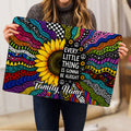 Person holding a colorful hippie sunflower doormat with psychedelic patterns and an uplifting message