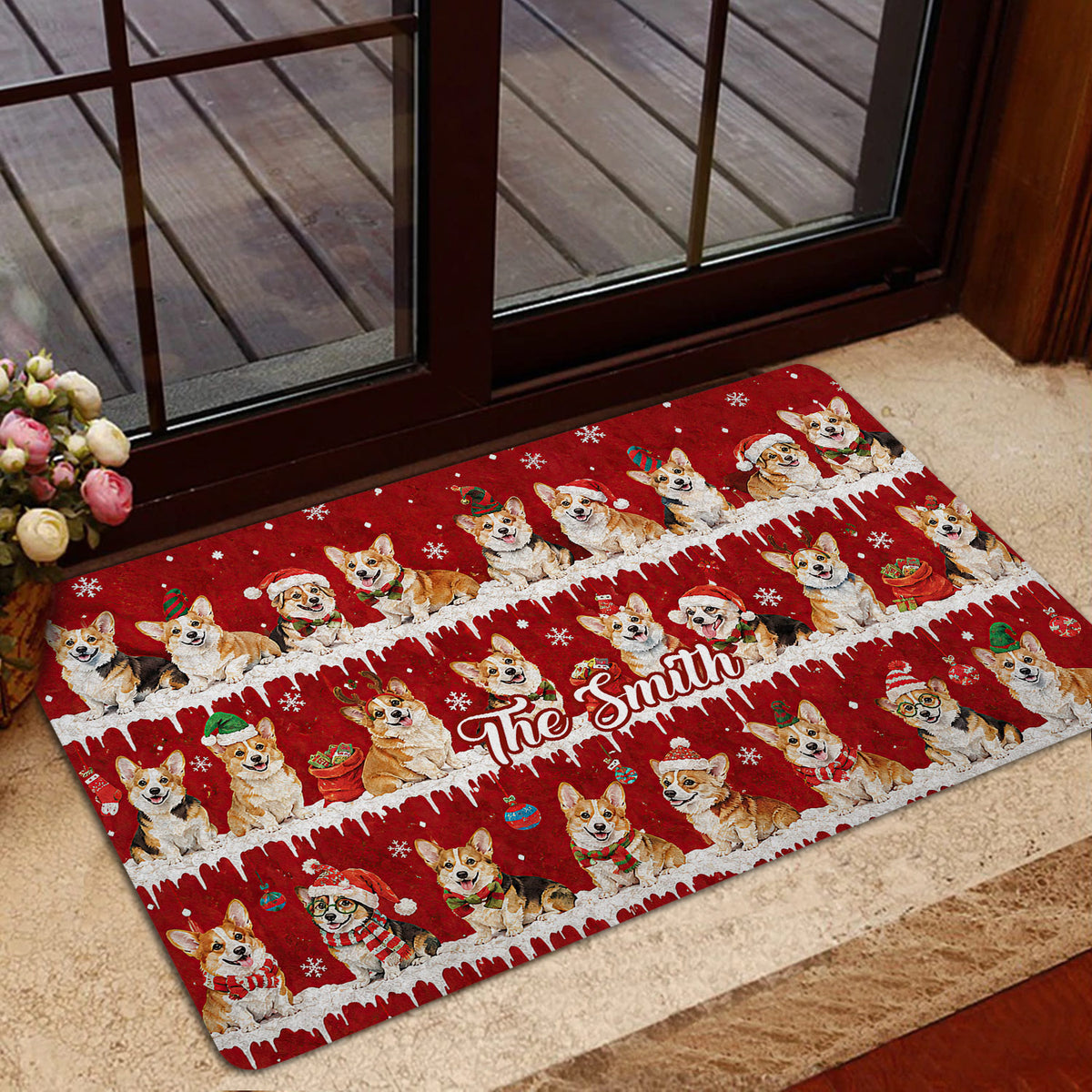 Holiday corgi door mat styled at a glass entrance with rows of festive corgis on a bright red background