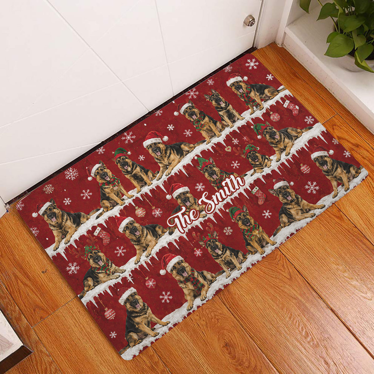 German Shepherd Christmas doormat displayed at an indoor entryway beside a white door and wood floor