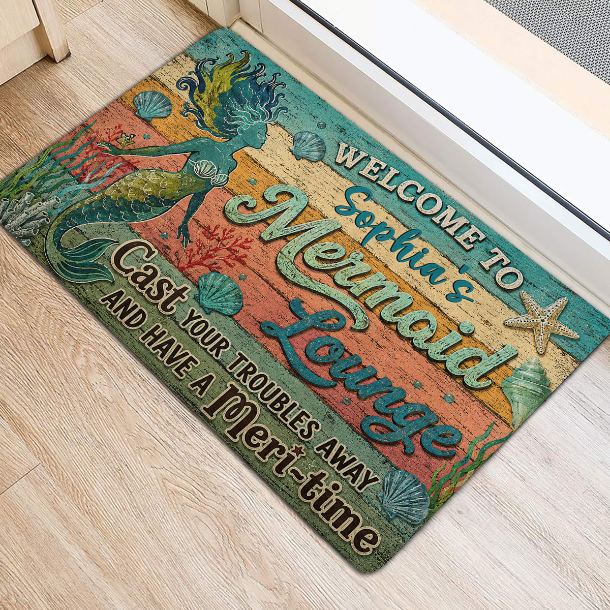Mermaid door mat styled at an entrance with colorful underwater artwork and seashell details