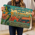 Mermaid doormat held indoors, showing colorful sea life artwork and welcoming entryway design