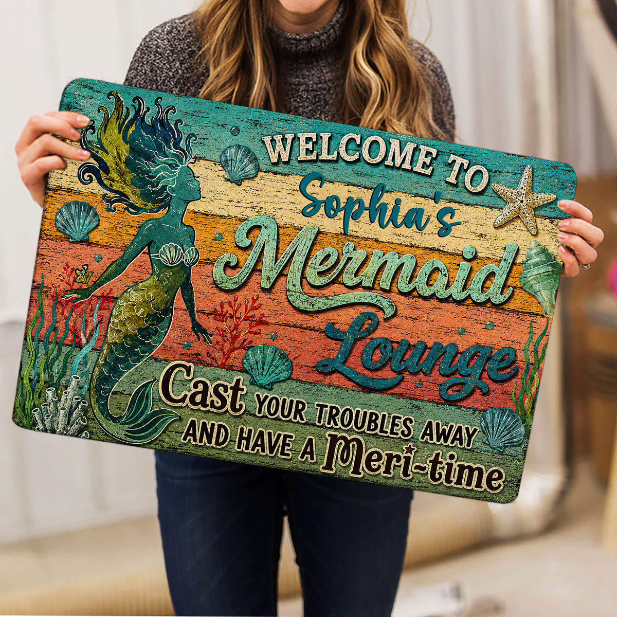 Mermaid doormat held indoors, showing colorful sea life artwork and welcoming entryway design