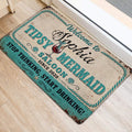 Turquoise and cream mermaid door mat displayed beside a bright entryway on light flooring