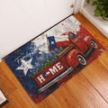 Texas-themed doormat displayed at an entryway, featuring a red vintage truck, Texas flag, bluebonnets, and bold patriotic artwork