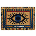 Evil eye doormat with a blue and gold eye motif, geometric border, and ornate floral pattern