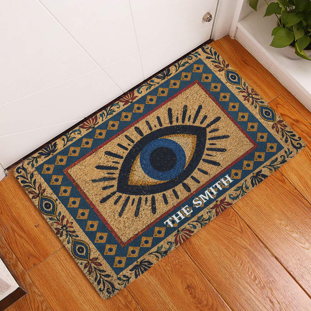 Evil eye entryway rug displayed by a white door on warm wood flooring