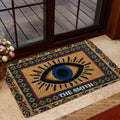 Ornate evil eye floor mat styled near a glass door in a warm home entryway