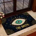 Evil eye entryway rug styled near a glass door with dark blue, gold, and turquoise artwork