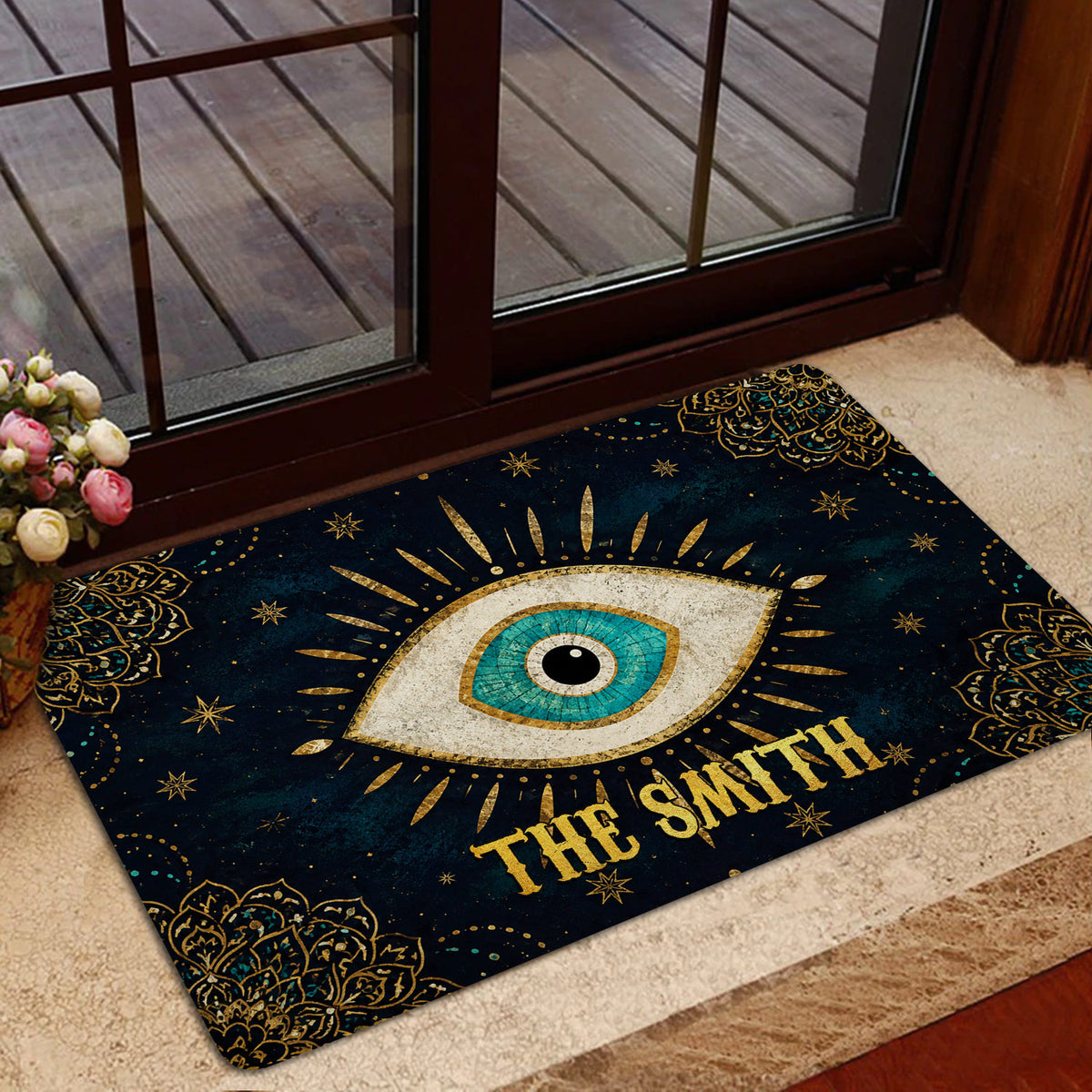 Evil eye entryway rug styled near a glass door with dark blue, gold, and turquoise artwork