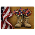 Patriotic veteran doormat featuring combat boots, American flags, red white and blue flowers, and a folded flag