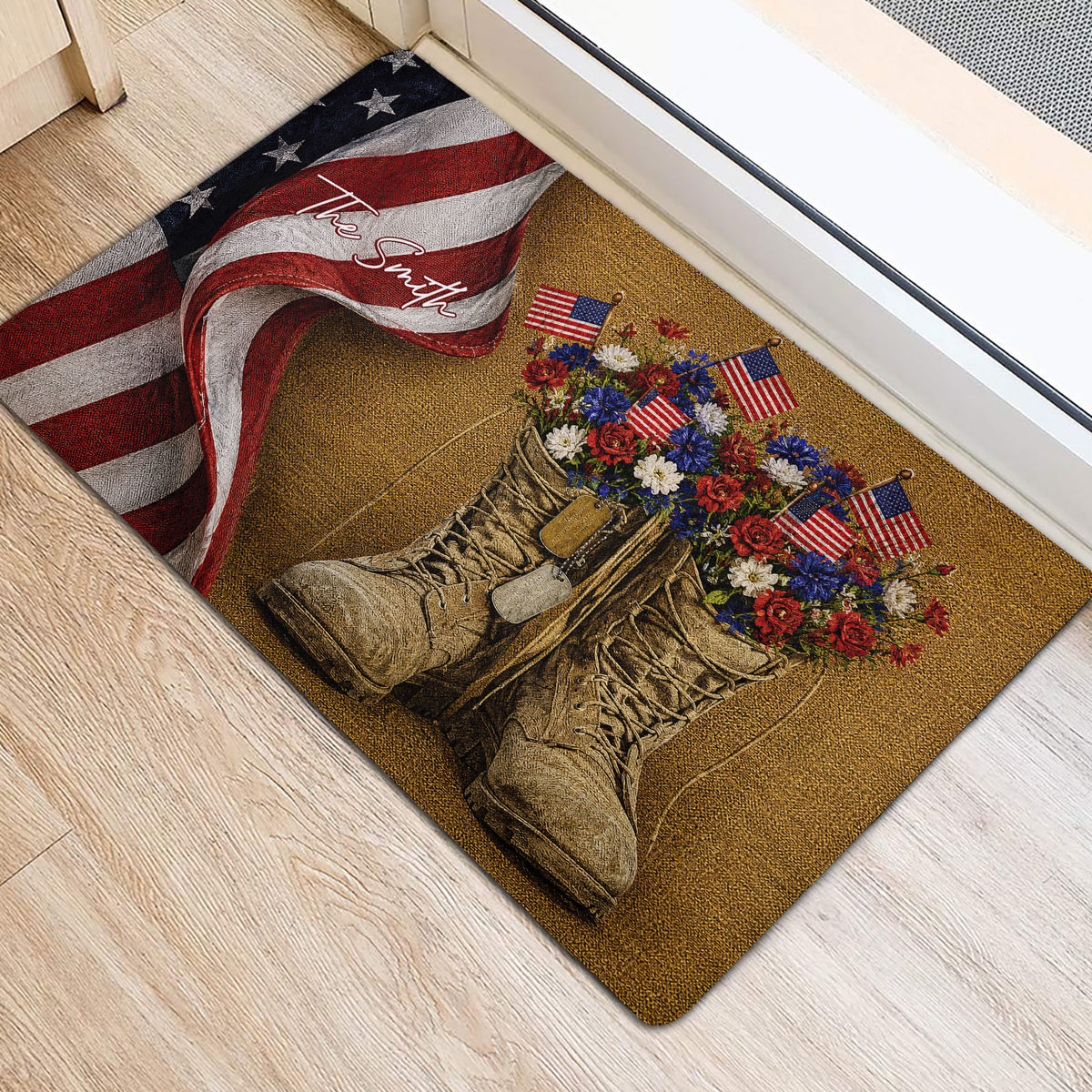 Veteran-themed entryway mat beside a doorway with combat boots, patriotic flowers, flags, and a folded flag