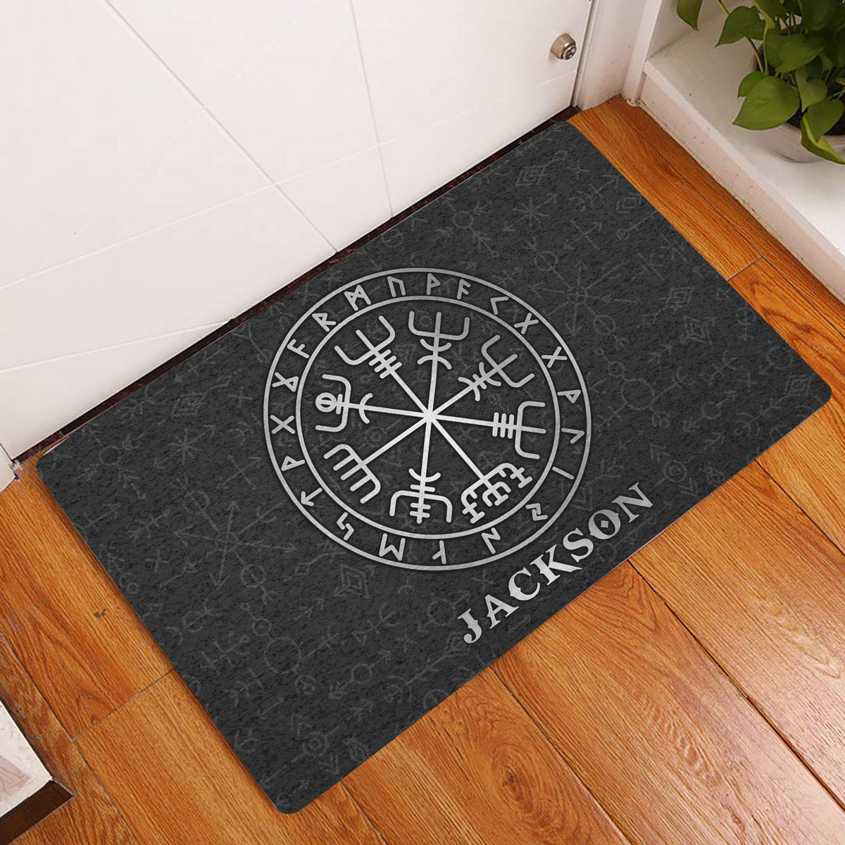 Viking doormat displayed at a home entrance with dark runic artwork and a circular Norse symbol
