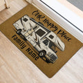 Illustrated camper van camping doormat positioned near a doorway on light wood flooring