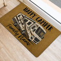 Golden camping doormat with recreational vehicle artwork positioned beside an interior doorway