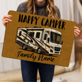 Camping doormat held indoors, showing a recreational vehicle design on a golden background