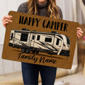 Camping RV doormat held indoors, featuring a detailed travel trailer illustration and welcoming camper artwork